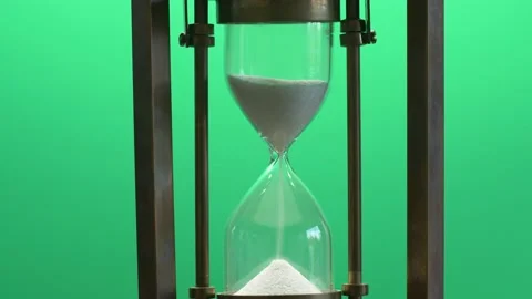Close-up of hourglass measuring passing time with running sand on green screen Stock Footage 143127825