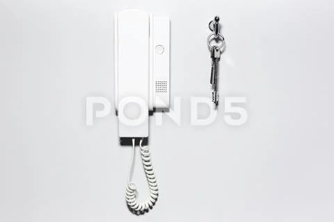 Close-up of house intercom and keys, on white wall background. Stock ...