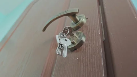 Close up of a house key left in a door lock. A concept of forgetting something Stock Footage 345601597