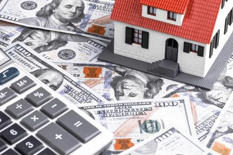 Close-up of a House Model with Calculator on Dollar Notes Stock Photos