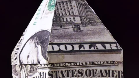 Close-up house model made with dollar banknote rotating on a board Stock Footage 248310320