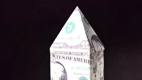 Close-up house model made with dollar banknote rotating Stock Footage 248368471
