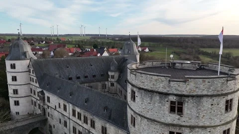 Close hover beside tower with flags moving in wind Stock Footage 331209285