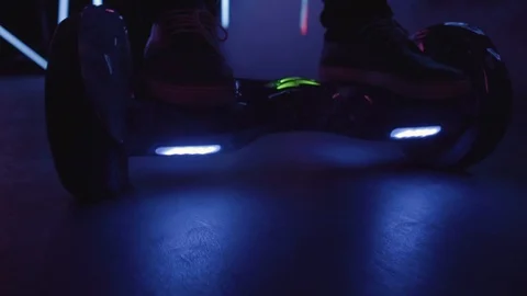 Close-up of a hoverboard in motion. Controlling the Balance GyroScooter. Neon. N Stock Footage 93706427