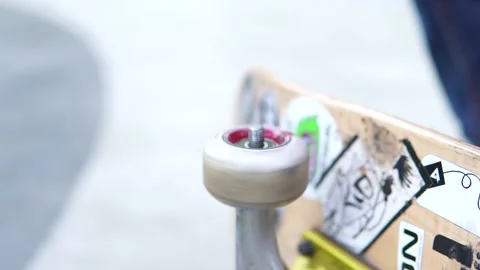 Close-up of how hands twists a colored wheel from a skate board in stickers 스톡 동영상 165036399