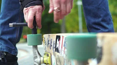 Close-up of how hands twists a colored wheel from a skate board in stickers 스톡 동영상 165036423