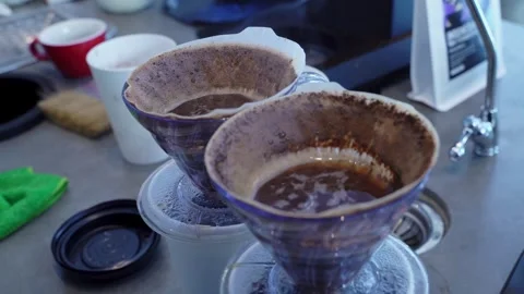 Close-up of how the v60 coffee funnels are being prepared. A coffee drink. Love Stock Footage 275246597