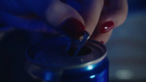 Close-up of how women's hands with red nails open a blue tin can of energy drink Stock Footage 247920051