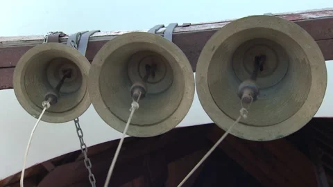Close-up of huge bells. Bell ringing inside church, without people in the frame Stock Footage 94084684