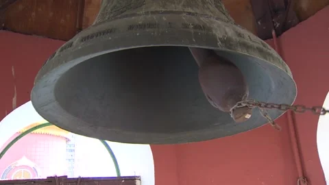 Close-up of huge bells. Bell ringing inside church, without people in the frame. Stock Footage 94084694