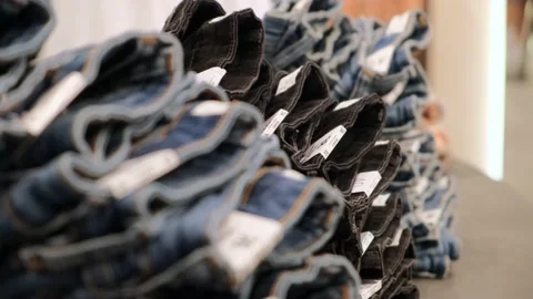 Close-up of a huge range of jeans in different sizes and styles for men and Stock Footage 217664046