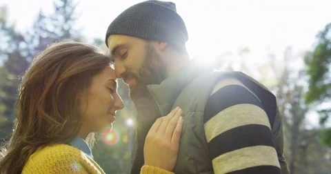 Close up of hugging and caressing romantic couple in the park on a sunny autumn Stock Footage 82511130