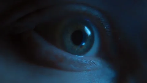 Close up of human eye looking at glowing display with screen reflection Stock Footage 318960420