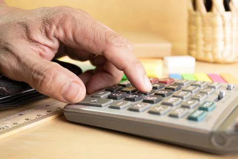 Close up human finger push number button of calculator concept Calculation .. Stock Photos