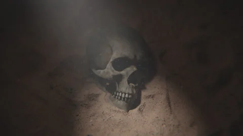 Close up of a human glowing skull in sand underwater in purple Stock Footage 253637146