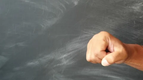 A close up of a human hand clenched into a tight fist against a dark background. Stock Footage 344796797