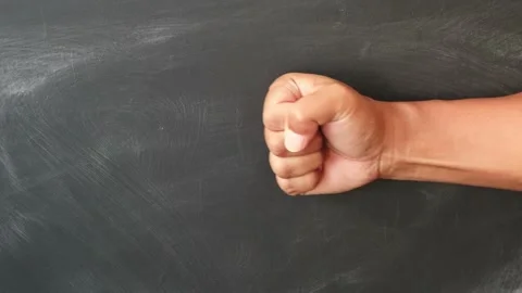 Close up of a human hand clenched into a tight fist isolated plain background Stock Footage 344797065
