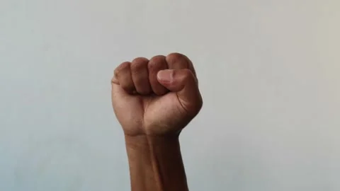 Close up of a human hand clenched into a tight fist isolated plain background Stock Footage 344797132