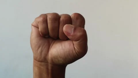 Close up of a human hand clenched into a tight fist isolated plain background Stock Footage 344797158