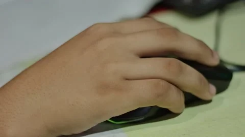 Close-up of a human hand clicking and navigating with a computer mouse on a.. Stock Footage 338225810