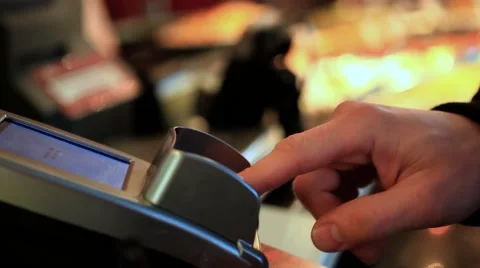 Close-up of human hand holding plastic card in payment machine and take off Card Stock Footage 47469506