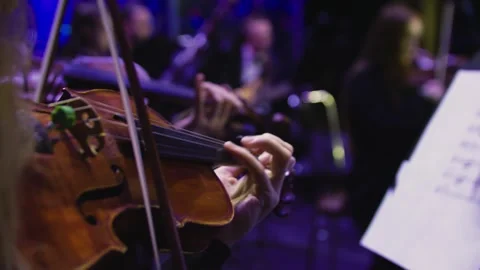 Close-up of a human hand playing the violin at the concert. Orchestra. Stock Footage 303407758