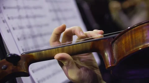 Close-up of a human hand playing the violin at the concert. Orchestra. Stock-Footage 303407766