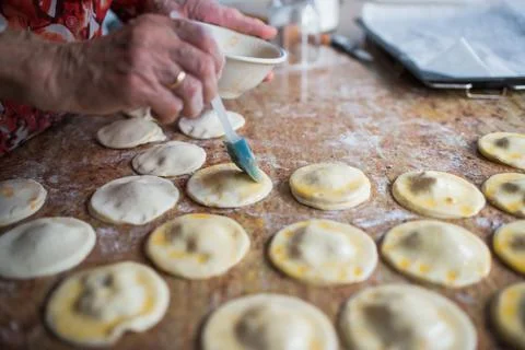 Close up of human hand preparing puff pastry damplings Stock Photos