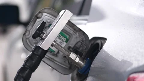 Close-up of Human hand refueling car at gas station pump,Slow motion Stock Footage 166874493