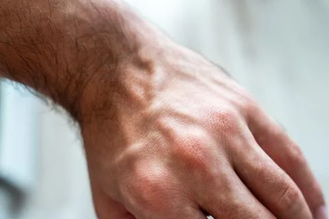 Close-up of a human hand resting on a flat surface, showcasing the skin texture Stock Photos