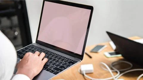 Close-Up Of Human Hand Typing Documents On Keyboard Of Laptop Stock Photos