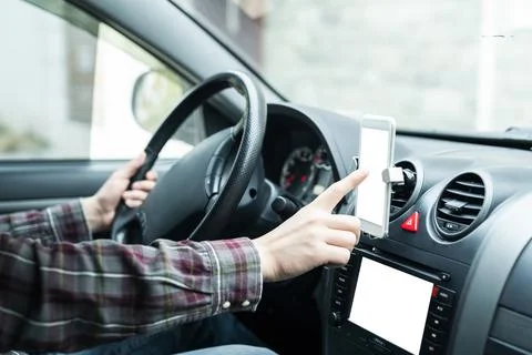 Close up of human hand using smartphone in a car Stock Photos