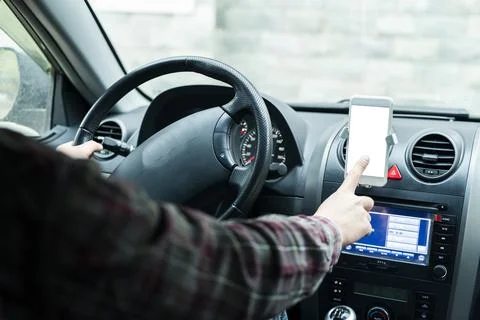 Close up of human hand using smartphone in a car Stock Photos