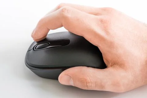 Close-up of a human hand while using a computer mouse on a white background Stockfoto's