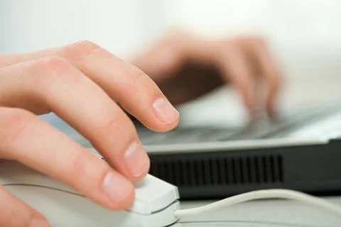 Close-up of human hand on white mouse during computer work Stock Photos
