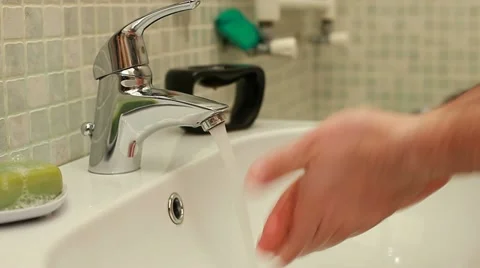 Close-up of human hands being washed under stream of water Stock Footage 11218448