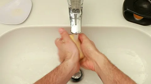 Close-up of human hands being washed under stream of water Stock Footage 11218802