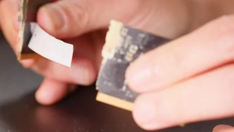 Close Up of Human Hands Breaking a Computer RAM Circuit Board Stock Footage 328063487