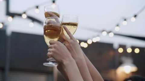 Close-up of human hands cheering up with flutes of golden champagne Stock Footage 124100209
