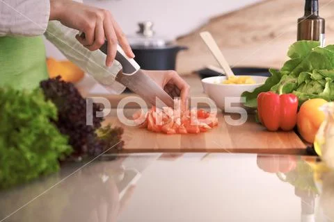 Close Up of human hands cooking vegetable salad in kitchen on the glass table Stock Photos