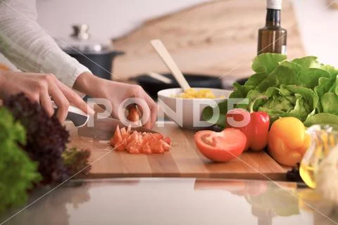 Close Up of human hands cooking vegetable salad in kitchen on the glass table Stock Photos