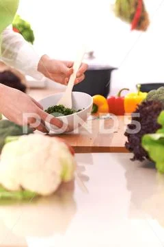Close Up of human hands cooking vegetable salad in kitchen on the glass table Stock Photos