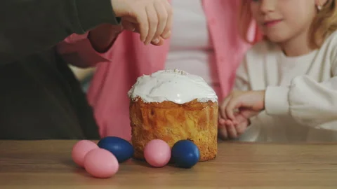 Close up of the human hands decorating the easter cake with her grandmother in Stock Footage 234144010