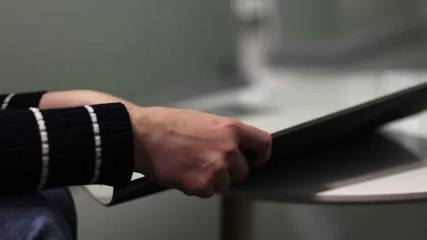 Close-up of human hands flipping through a magazine Stock Footage 321743903