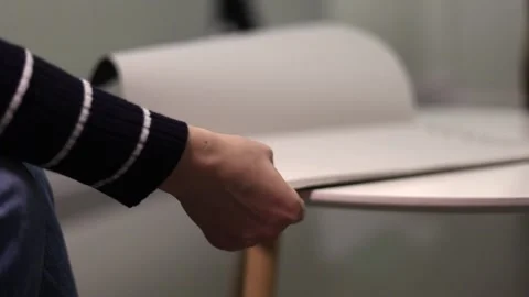 Close-up of human hands flipping through a magazine Stock Footage 321743942