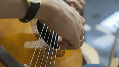 Close-up of human hands playing classical guitar Stock Footage 114626951