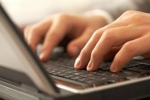 Close-up of human hands pushing keys of laptop or computer Stock Photos