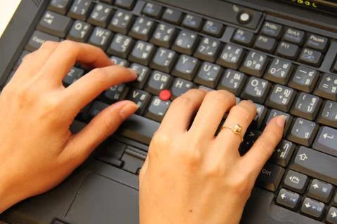 Close-up of human hands pushing keys of laptop or computer Stock Photos