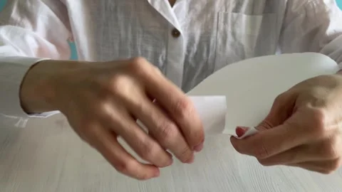 Close-up of human hands ripping white paper into pieces on a table,sharp te.. Stock Footage 329916404