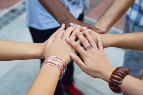 Close-up of human hands stacked upon one another Stock Photos